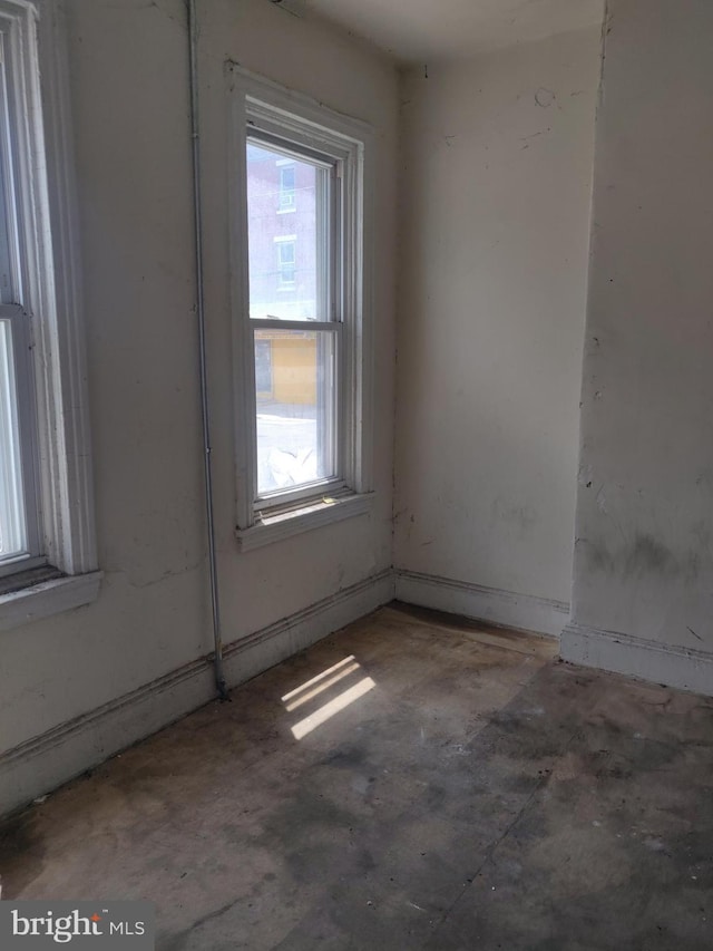 1302 N 25th St, Philadelphia, PA 19121 - empty room featuring plenty of natural light and unfinished concrete flooring