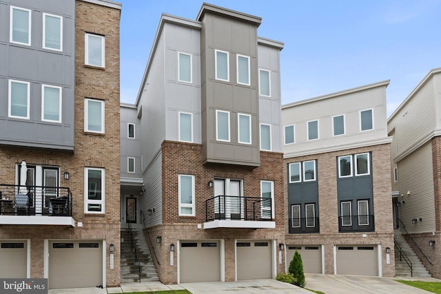 15590 Grade Line Pl, Woodbridge, VA 22191 - view of front of house with a garage, stairway, driveway, and brick siding
