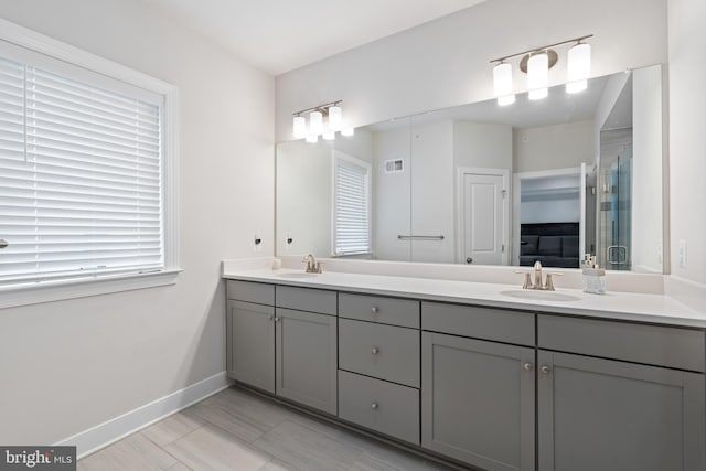 15590 Grade Line Pl, Woodbridge, VA 22191 - bathroom featuring double vanity and baseboards