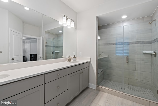 15590 Grade Line Pl, Woodbridge, VA 22191 - full bathroom with double vanity, a shower stall, recessed lighting, and baseboards