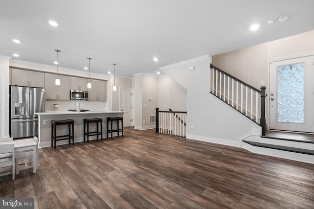 15590 Grade Line Pl, Woodbridge, VA 22191 - living area with crown molding, dark wood-type flooring, recessed lighting, baseboards, and stairway