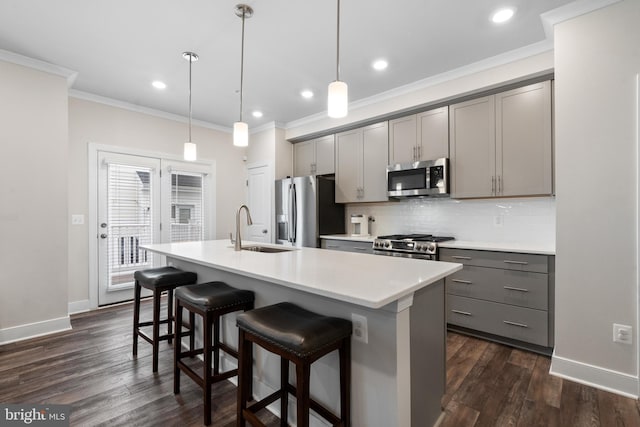 15590 Grade Line Pl, Woodbridge, VA 22191 - kitchen featuring gray cabinets, stainless steel appliances, a sink, crown molding, and an island with sink