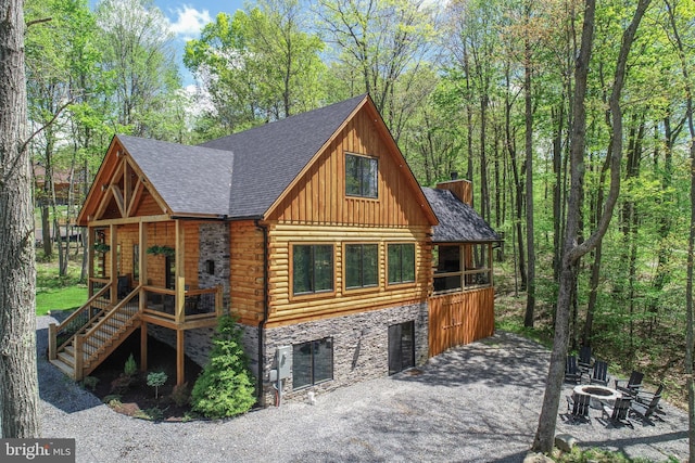 1067 N Camp Rd, Mc Henry, MD 21541 - view of front of property featuring a fire pit, stone siding, stairway, board and batten siding, and a shingled roof