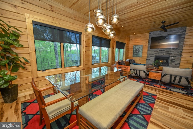 1067 N Camp Rd, Mc Henry, MD 21541 - dining room featuring wooden walls, wooden ceiling, a stone fireplace, wood finished floors, and a chandelier