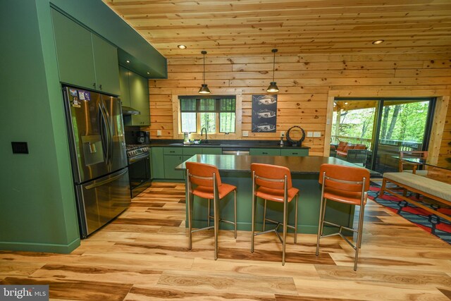 1067 N Camp Rd, Mc Henry, MD 21541 - kitchen with green cabinetry, stainless steel fridge, range with gas cooktop, dark countertops, and wood ceiling