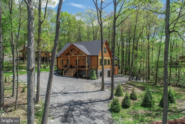 1067 N Camp Rd, Mc Henry, MD 21541 - view of front facade with a porch, log siding, asphalt driveway, stairs, and a view of trees