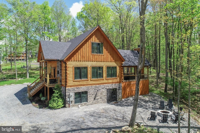 1067 N Camp Rd, Mc Henry, MD 21541 - view of front of house featuring an outdoor fire pit, log exterior, board and batten siding, stairs, and stone siding