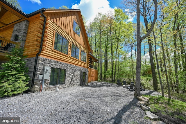1067 N Camp Rd, Mc Henry, MD 21541 - view of property exterior featuring board and batten siding, stone siding, log siding, and a fire pit