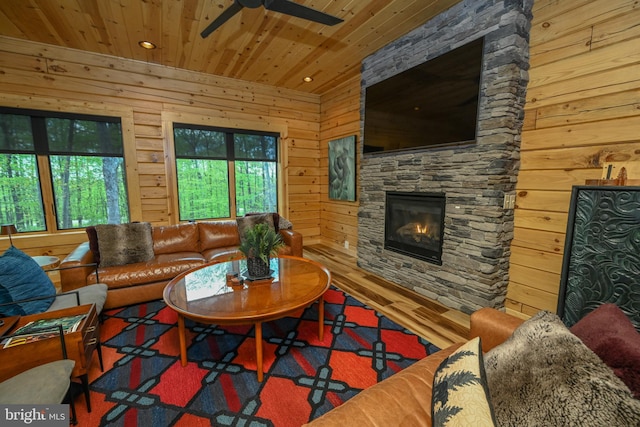1067 N Camp Rd, Mc Henry, MD 21541 - living room with wooden ceiling, ceiling fan, a stone fireplace, wood finished floors, and wooden walls