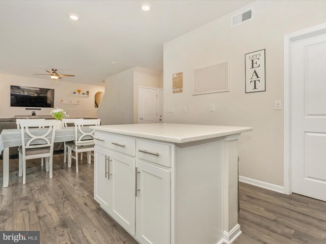 5809 Zoe Ln, Frederick, MD 21704 - kitchen with a ceiling fan, wood finished floors, white cabinetry, light countertops, and a center island