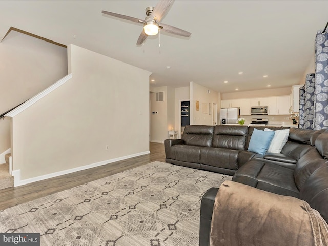5809 Zoe Ln, Frederick, MD 21704 - living area featuring ceiling fan, wood finished floors, stairway, baseboards, and recessed lighting