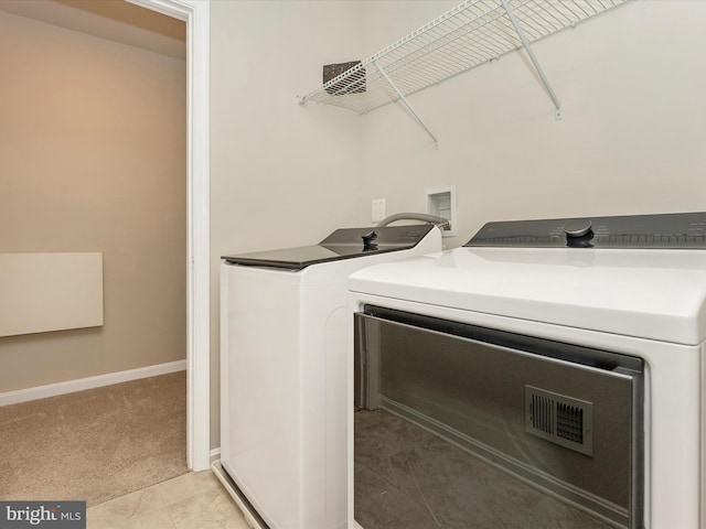 5809 Zoe Ln, Frederick, MD 21704 - washroom with washing machine and dryer, light colored carpet, and baseboards