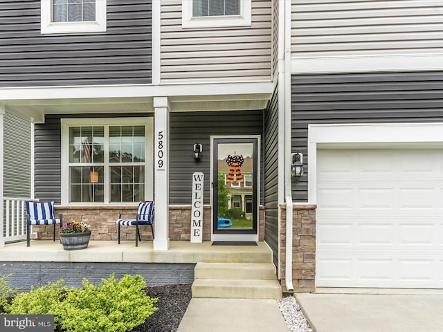 5809 Zoe Ln, Frederick, MD 21704 - entrance to property with stone siding, a porch, and an attached garage