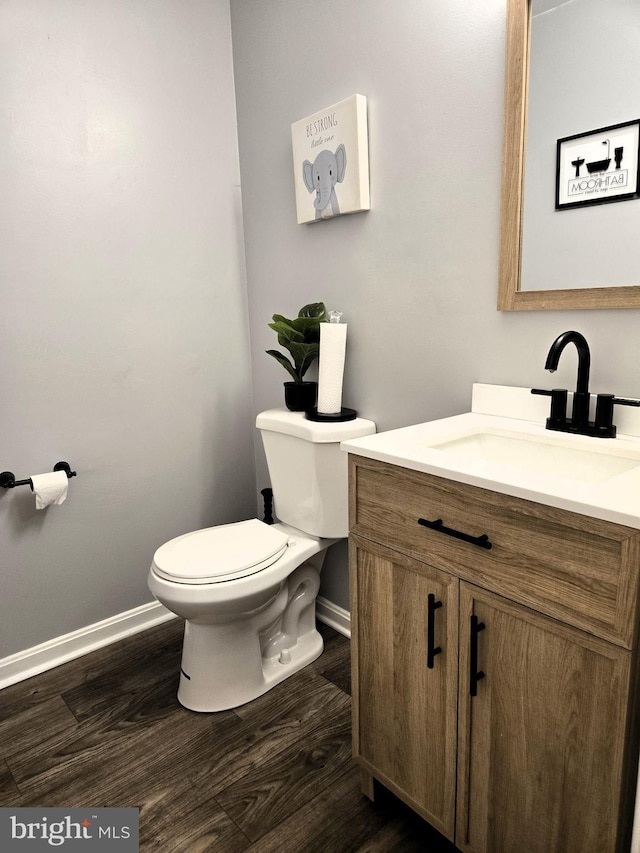 7832 Canter Ct, Severn, MD 21144 - bathroom with baseboards, wood finished floors, toilet, and vanity