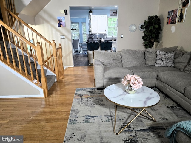 7832 Canter Ct, Severn, MD 21144 - living room featuring light wood-style flooring, stairs, and baseboards