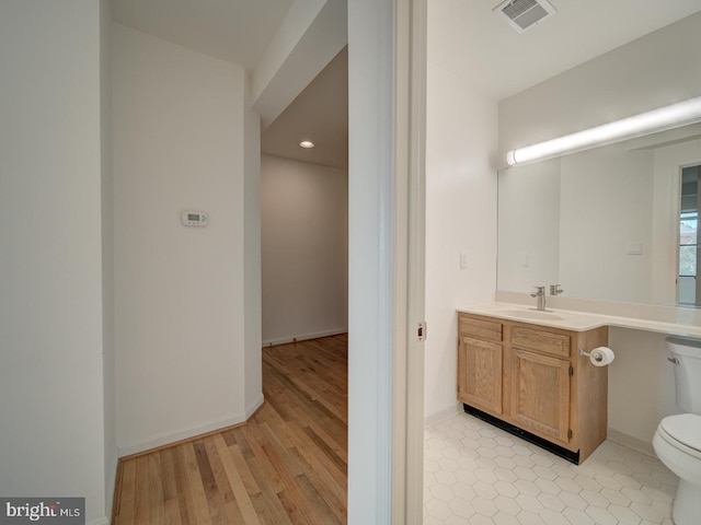 1812 Vernon St NW Unit 42, Washington, DC 20009 - bathroom featuring toilet, vanity, recessed lighting, wood finished floors, and baseboards