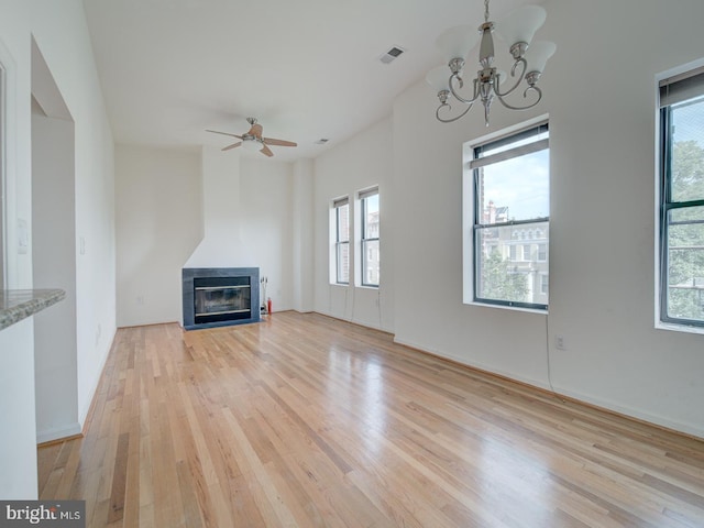 1812 Vernon St NW Unit 42, Washington, DC 20009 - unfurnished living room with light wood-style floors, plenty of natural light, a chandelier, and a fireplace with flush hearth