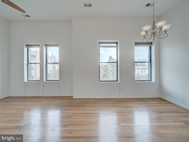 1812 Vernon St NW Unit 42, Washington, DC 20009 - spare room with a chandelier, light wood finished floors, and baseboards