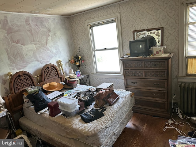 1533 N Carolina Ave NE, Washington, DC 20002 - bedroom featuring wallpapered walls, dark wood-type flooring, radiator heating unit, multiple windows, and ornamental molding