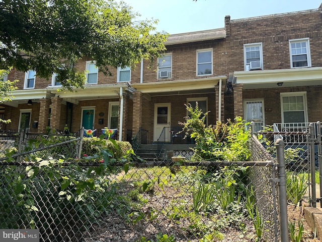 1533 N Carolina Ave NE, Washington, DC 20002 - view of property featuring covered porch, brick siding, and a fenced front yard