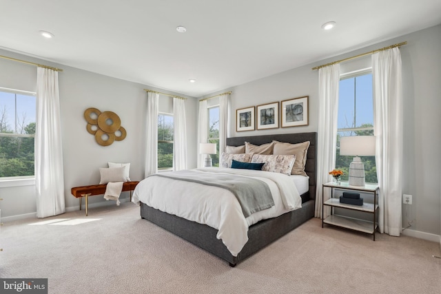 bedroom with light colored carpet, baseboards, and recessed lighting