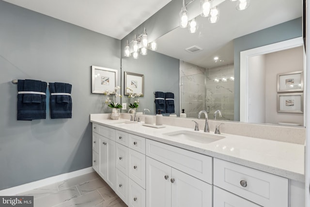 full bath with baseboards, marble finish floors, a stall shower, and double vanity