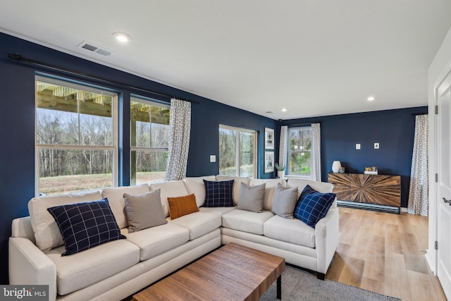 living area featuring light wood-type flooring and recessed lighting