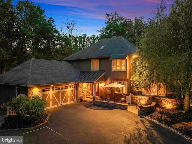 3097 Mill Rd, Doylestown, PA 18902 - view of front of home with a shingled roof, stone siding, driveway, a garage, and a standing seam roof