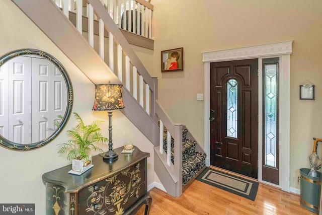 3097 Mill Rd, Doylestown, PA 18902 - entryway with stairs, wood finished floors, baseboards, a high ceiling, and plenty of natural light