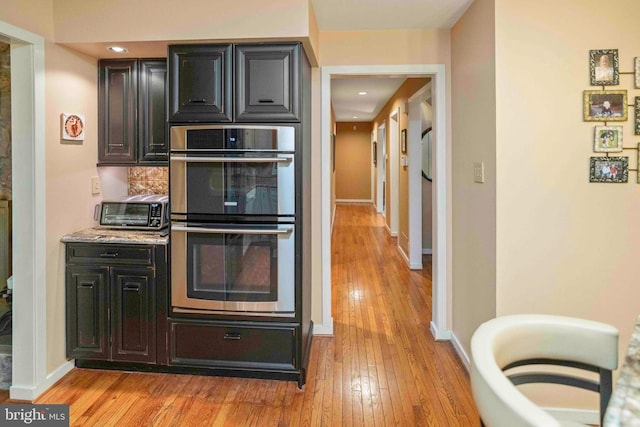 3097 Mill Rd, Doylestown, PA 18902 - kitchen featuring double oven, light wood-style flooring, baseboards, backsplash, and recessed lighting