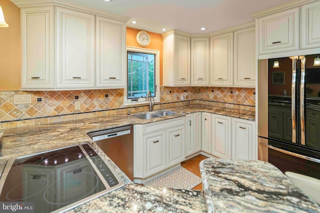 3097 Mill Rd, Doylestown, PA 18902 - kitchen with a sink, black refrigerator, dishwasher, cream cabinets, and stone countertops