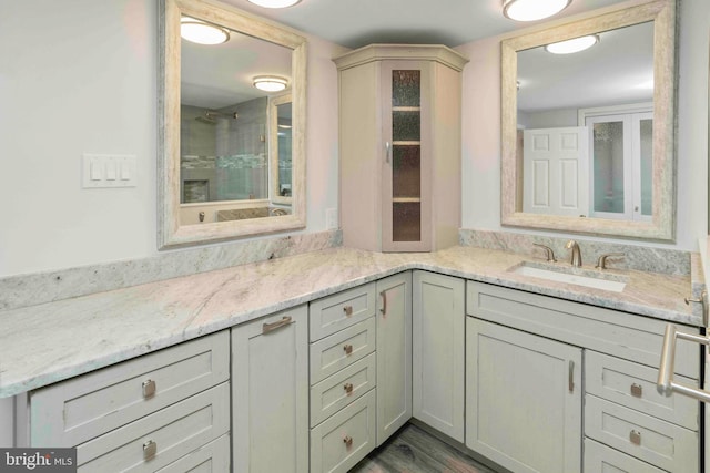 3097 Mill Rd, Doylestown, PA 18902 - full bathroom with double vanity, a tile shower, and wood finished floors