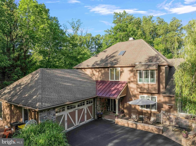 3097 Mill Rd, Doylestown, PA 18902 - view of front of home featuring a shingled roof, a standing seam roof, stone siding, and a garage