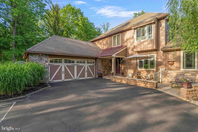 3097 Mill Rd, Doylestown, PA 18902 - view of front of home featuring stone siding, driveway, an attached garage, and a shingled roof