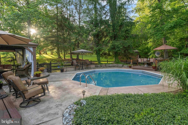 3097 Mill Rd, Doylestown, PA 18902 - swimming pool with a gazebo, a patio, outdoor dining space, and view of wooded area