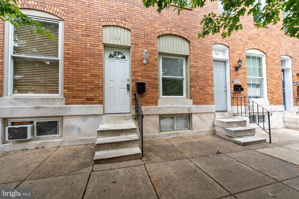 328 S Macon St, Baltimore, MD 21224 - doorway to property with brick siding