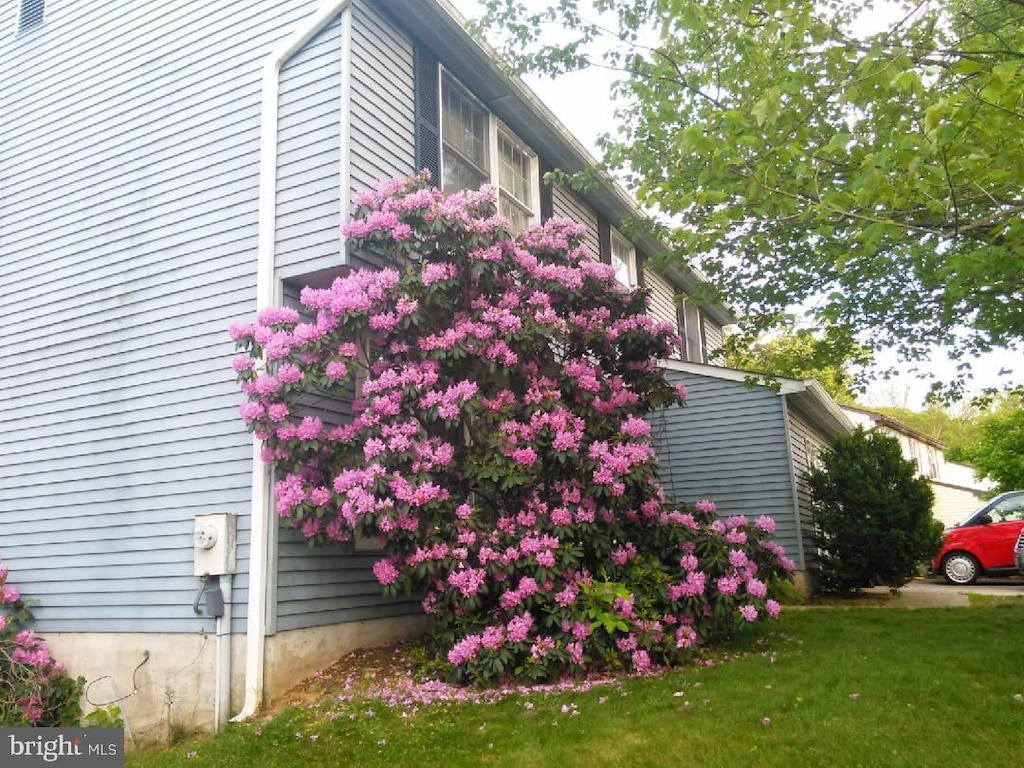 view of side of home with a lawn