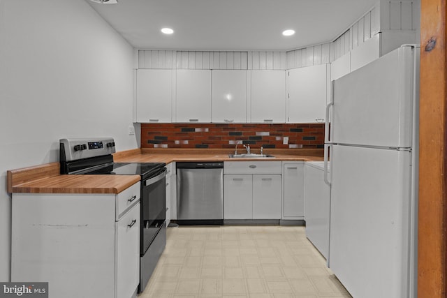 78 Cobalt Ridge Dr Unit E, Levittown, PA 19057 - kitchen featuring appliances with stainless steel finishes, a sink, light floors, white cabinetry, and washer / clothes dryer