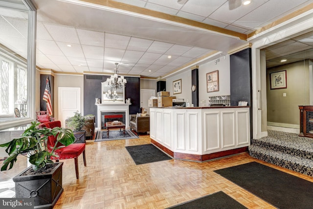 1001 Saint Paul St Unit 2D, Baltimore, MD 21202 - reception featuring a fireplace, a chandelier, crown molding, and recessed lighting
