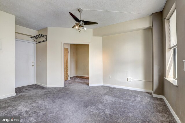1001 Saint Paul St Unit 2D, Baltimore, MD 21202 - carpeted spare room featuring a ceiling fan, a textured ceiling, and baseboards