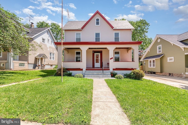 view of front of property with stucco siding, a porch, and a front yard