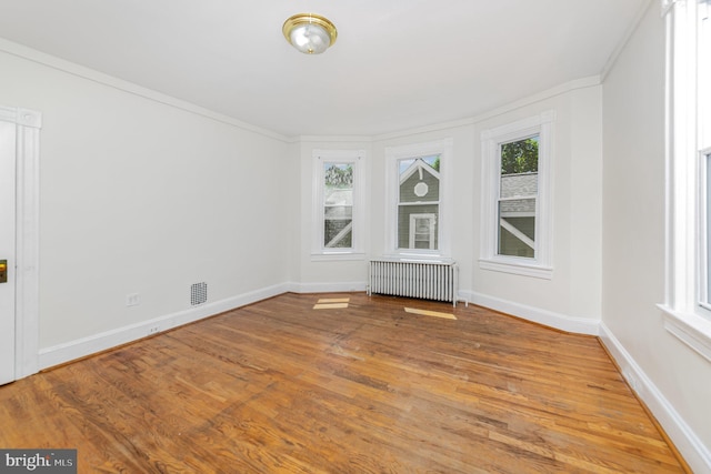 unfurnished sunroom featuring radiator heating unit