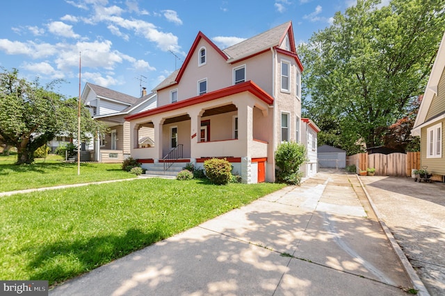 victorian house featuring stucco siding, covered porch, and a shingled roof