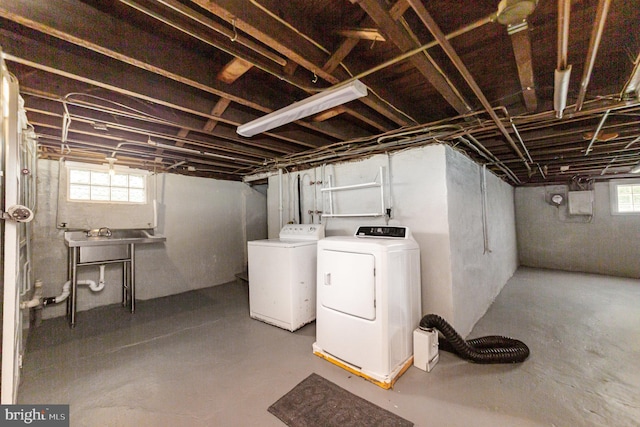 below grade area with washer and dryer, plenty of natural light, and a sink