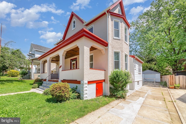 victorian-style house with covered porch, stucco siding, and a garage