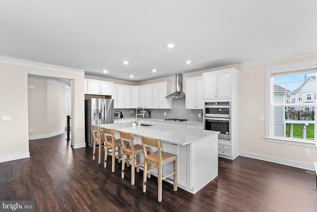 19253 Running Spring Ct, Leesburg, VA 20175 - kitchen with stainless steel appliances, wall chimney range hood, dark wood-type flooring, a sink, and crown molding