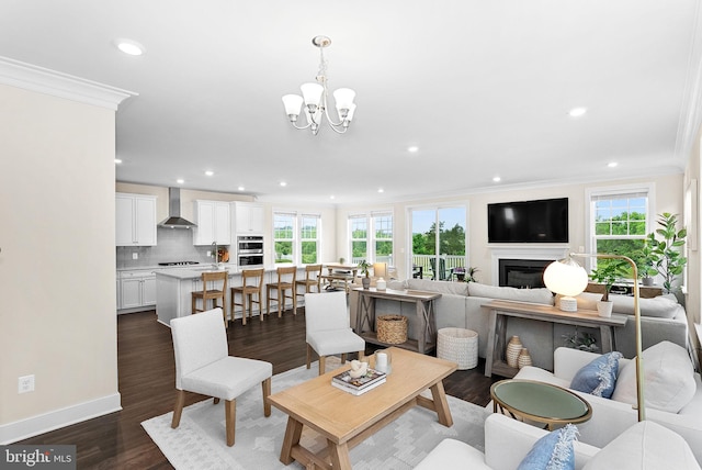 19253 Running Spring Ct, Leesburg, VA 20175 - living area with crown molding, a chandelier, recessed lighting, a fireplace, and dark wood finished floors