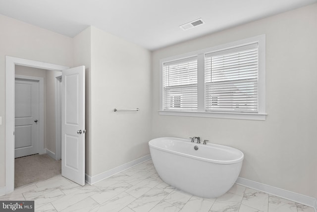 19253 Running Spring Ct, Leesburg, VA 20175 - full bath with marble finish floors, a freestanding bath, and baseboards