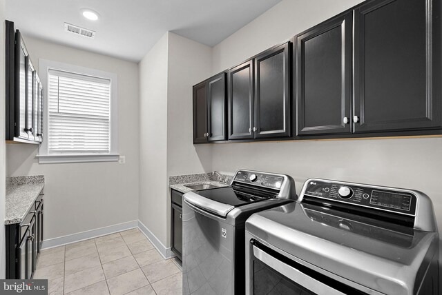 19253 Running Spring Ct, Leesburg, VA 20175 - laundry area featuring cabinet space, separate washer and dryer, baseboards, and light tile patterned flooring