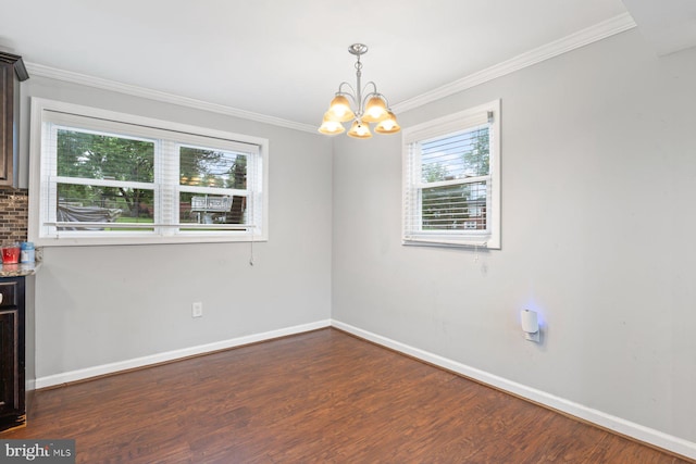 10700 Bickford Ave, Clinton, MD 20735 - unfurnished dining area with a chandelier, dark wood-style flooring, baseboards, and crown molding